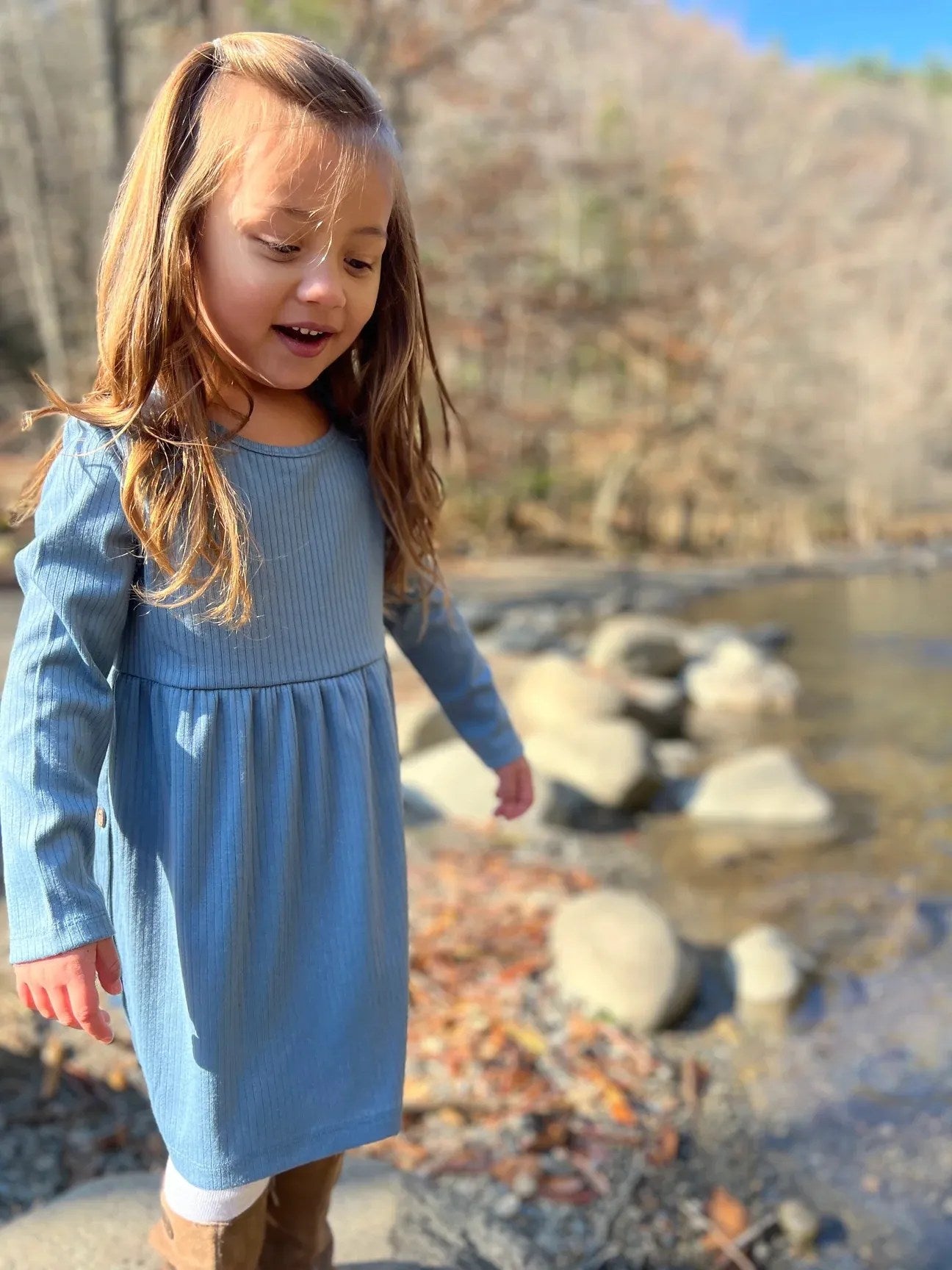 girl with blue long sleeve knee length dress