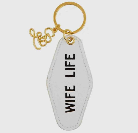 white vintage motel ring shaped keychain with gold key ring, tag reads wife life